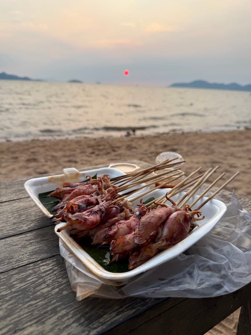 Grilled squid trays on the Kampot beach